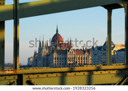 The Hungarian Parlilament's buiding framed with the Szechenyi Chain  bridge. The bridge conditions is poor but renovation works begin in 2021. Famous tourist attraction Royalty-Free Stock Photo #1928323256