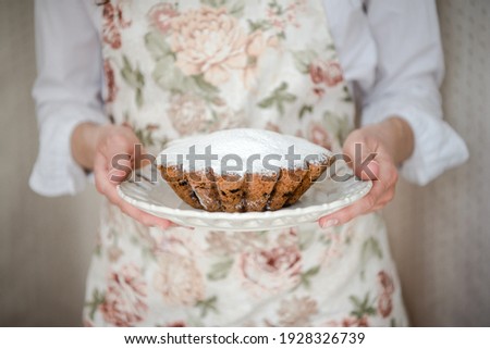 Homemade vanilla cake with raisins and sugar powder. Selective focus. Copy space for your text.