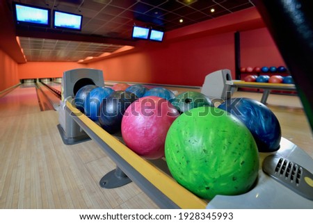 Bowling balls and wooden lane in bowling hall