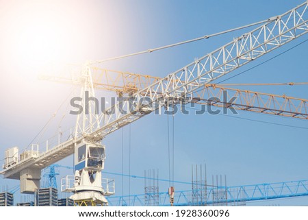 High-rise crane for the construction of multi-storey buildings. Empty place in the photo. Can be used as a background.
