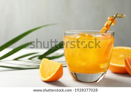 Delicious orange soda water on white table