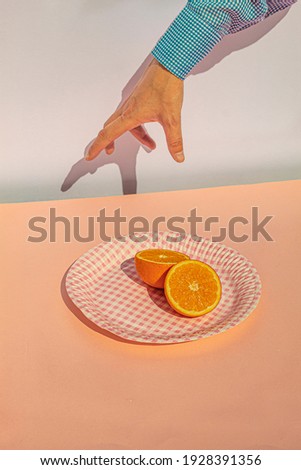 Arm of woman holding oranges