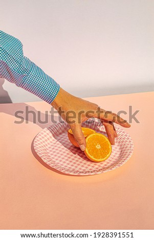 Arm of woman holding oranges