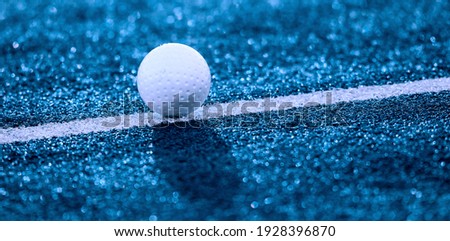 White ball for playing field hockey. Blue color filter