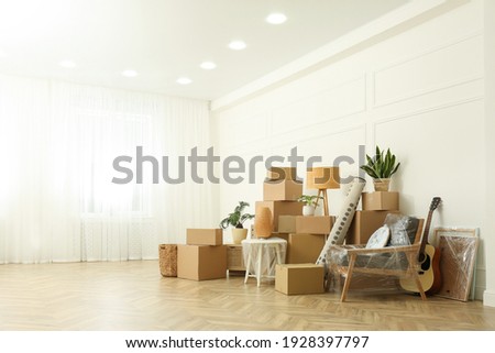 Cardboard boxes and household stuff indoors, space for text. Moving day Royalty-Free Stock Photo #1928397797