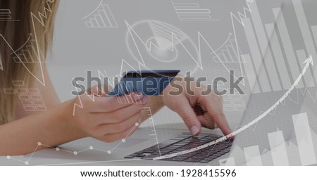 Financial data processing over woman holding credit card and using laptop. global business and finance concept digitally generated image.