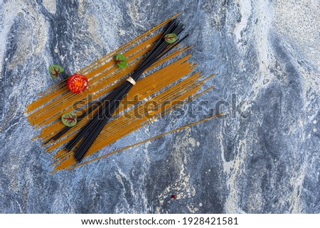 Italian pasta on a blue concrete background. Top view