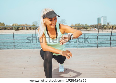 Woman looking at smartwatch heart rate monitor. Healthy lifestyle concept. Royalty-Free Stock Photo #1928424266