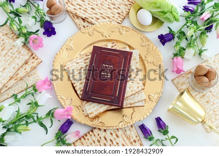 Pesah celebration concept (jewish Passover holiday). Traditional book with text in hebrew: Passover Haggadah (Passover Tale) Royalty-Free Stock Photo #1928432909