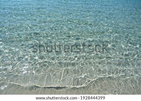 The crystalline waters of the Mediterranean sea in Sicily with intense turquoise and blue reflections for a healthy bath in the aromas of saltiness. Royalty-Free Stock Photo #1928444399