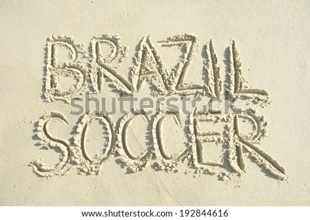 Football handwritten soccer message in capital letter text on bright sunny Brazilian sand beach