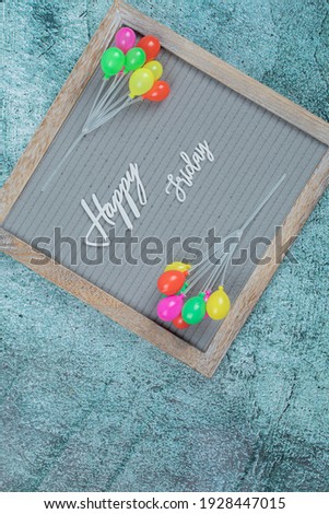 Happy friday embedded on grey background with toy balloons