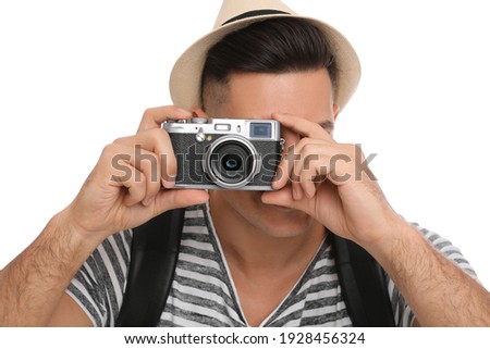 Man with straw hat taking picture on white background, closeup. Summer travel