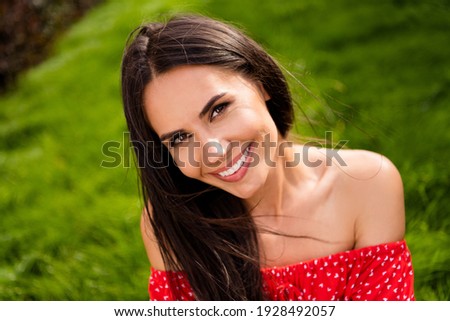 Photo of adorable shiny young lady wear red off-shoulders dress sitting green grass relaxing outside countryside