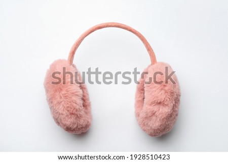 Stylish winter earmuffs on white background, top view Royalty-Free Stock Photo #1928510423