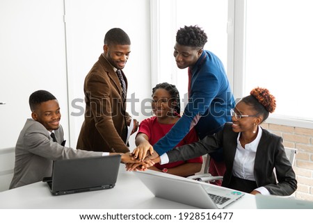 team of young african people in the office at the table with laptops  Royalty-Free Stock Photo #1928516477