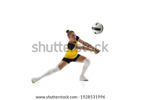 Ready. Young female volleyball player isolated on white studio background. Woman in sportswear training and practicing in action, flight. Concept of sport, healthy lifestyle, motion and movement. Royalty-Free Stock Photo #1928531996