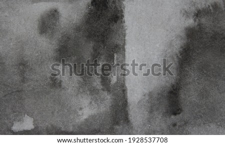 Black background. Old black paper texture with streaks of black and gray paint. Watercolor abstract black background in grunge style