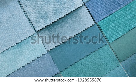 close up catalog of interior luxury fabric sample chart showing multi texture and pattern blue ,cyan and turquoise color tone. interior drapery and curtain samples palette.