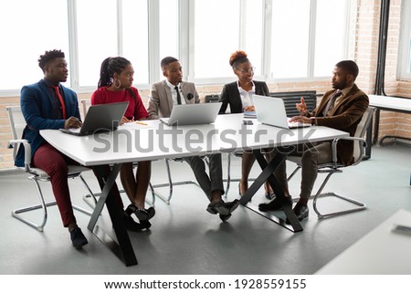 team of young african people in the office at the table with a laptop  Royalty-Free Stock Photo #1928559155