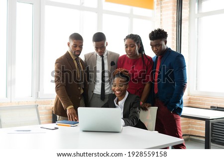team of young african people in the office at the table with a laptop  Royalty-Free Stock Photo #1928559158