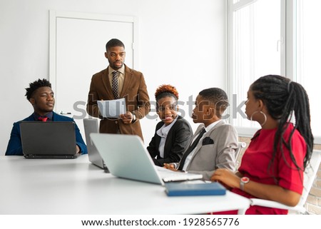team of young african people in the office at the table with a laptop  Royalty-Free Stock Photo #1928565776