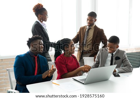 team of young african people in the office at the table with a laptop  Royalty-Free Stock Photo #1928575160