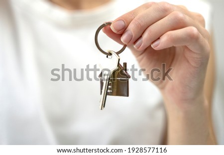 the key to your own home in the palm of the girl and a wooden