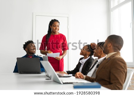 team of young african people in the office at the table with a laptop  Royalty-Free Stock Photo #1928580398