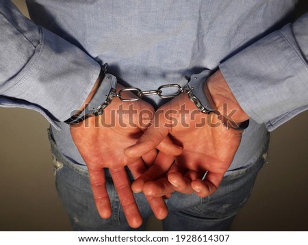 Handcuffs on arrested businessman hand, businessman loss freedom