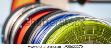 3D Printer Plastic filament for 3D printer and printed products in the interior of the design office  Royalty-Free Stock Photo #1928623370