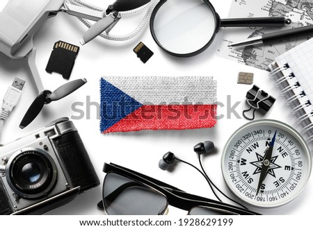 Flag of Czechia and travel accessories on a white background.