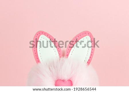 Easter background. Easter bunny ears on pink with copy space
