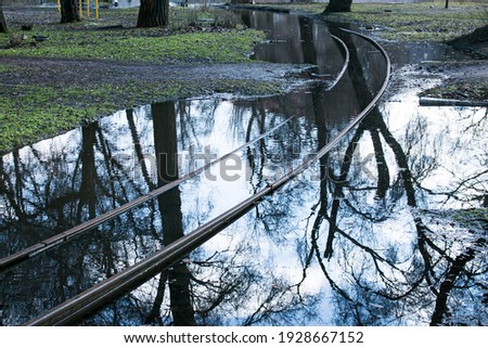 Spring. The snow melts, the water level in rivers and lakes rises. Flooding in the park. The tram rails are flooded with water.