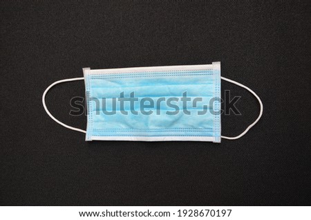 Surgical mask on a black background
