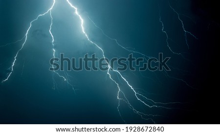 A low angle shot of the scary lightning in the night sky Royalty-Free Stock Photo #1928672840