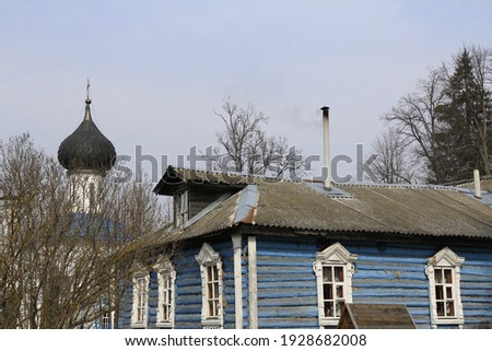 Roofs and domes in blue tones in the Russian village.