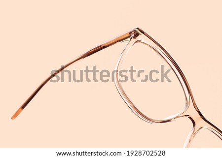 eyewear spectacles close up isolated on beige background Royalty-Free Stock Photo #1928702528