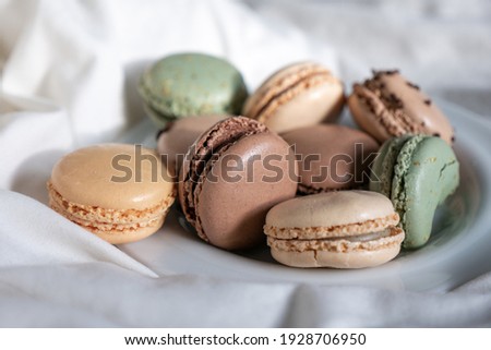 French Colorful Macarons Colorful Pastel Macarons on White Background green beige and Brown Macaron on plate dessert Sweet and colourful french macaroons pastry