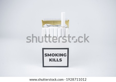 Quit smoking concept. Batch of cigarettes in a pack on the white background. Smoking kills sign on a pack