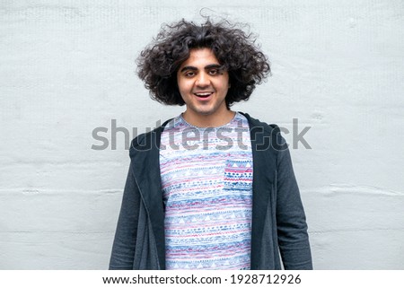 Middle Eastern man laughing at the camera