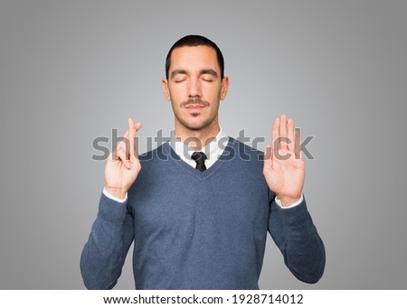 Serious young man with a gesture of oath