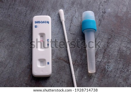 Covid-19 lateral flow test kit on grey surface Royalty-Free Stock Photo #1928714738