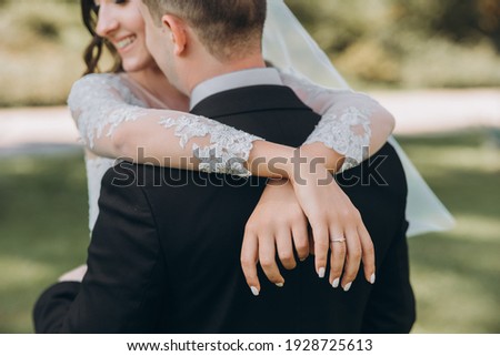 Happy bride and groom on their wedding. The groom kisses the forehead of the bride. Portrait of the bride. Newlyweds in the park. Happy couple. Wedding photo. Couple in love. Autumn wedding