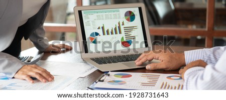 Financial analyst analysis business financial report on digital tablet during discussion at meeting of corporate showing the results of their successful teamwork. Royalty-Free Stock Photo #1928731643
