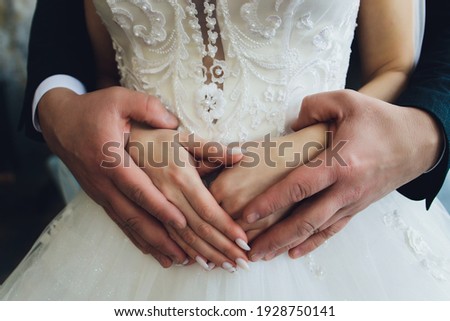 Hugs. Men's arm around the woman's waist. Lovers in the arms. Man embraces girl. Royalty-Free Stock Photo #1928750141