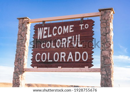 Welcome to colorful Colorado sign along the Colorado and Wyoming state border.