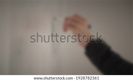 Defocused people writing on white board