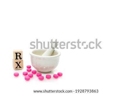 Hospital, clinic, healthcare and medical concept. RX with Mortar and Pestal with pink pills isolated on white background. Mortar and RX symbol using as pharmacy concept.
