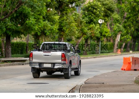 Rearview of a pickup truck on the road. Royalty-Free Stock Photo #1928823395
